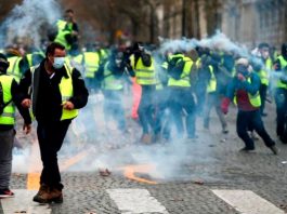 French Yellow Vest demonstrators  in Paris where the French riot police used tear gas rubber bullets and water cannon against them