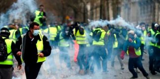 French Yellow Vest demonstrators  in Paris where the French riot police used tear gas rubber bullets and water cannon against them