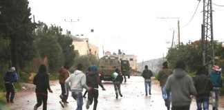 Palestinian youth battle with Israeli troops and settlers on the West Bank