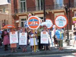 NHS cervical screening services threatened with privatisation! Protesters on the NHS 70th anniversary demonstration in June last year fighting against the privatisation of health services