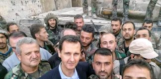 Syrian president BASHAR AL-ASSAD is welcomed by Syrian troops
