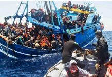 Refugees aboard an overloaded boat desperately trying to cross the Mediterranean