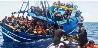 Refugees aboard an overloaded boat desperately trying to cross the Mediterranean