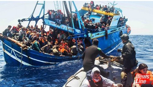 Refugees aboard an overloaded boat desperately trying to cross the Mediterranean