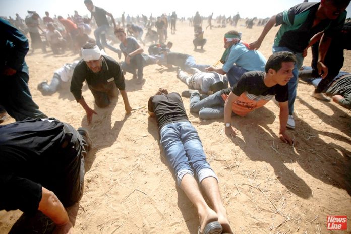 Palestinians on the Great March of Return on the Gaza border with Israel under attack from Israeli sniper fire